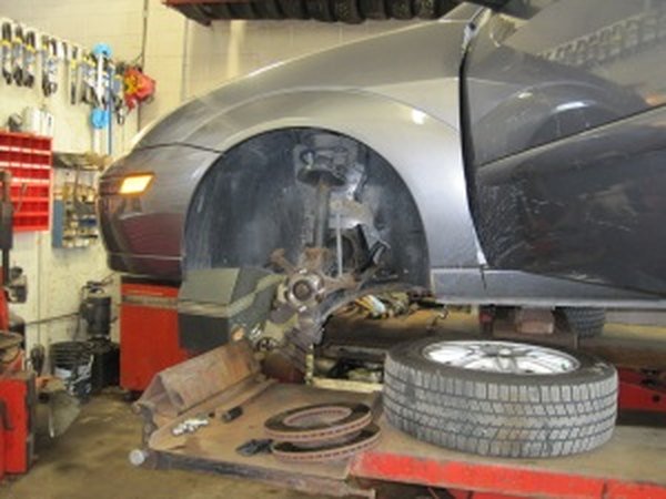 A brake job in progress on a lift at Ron's